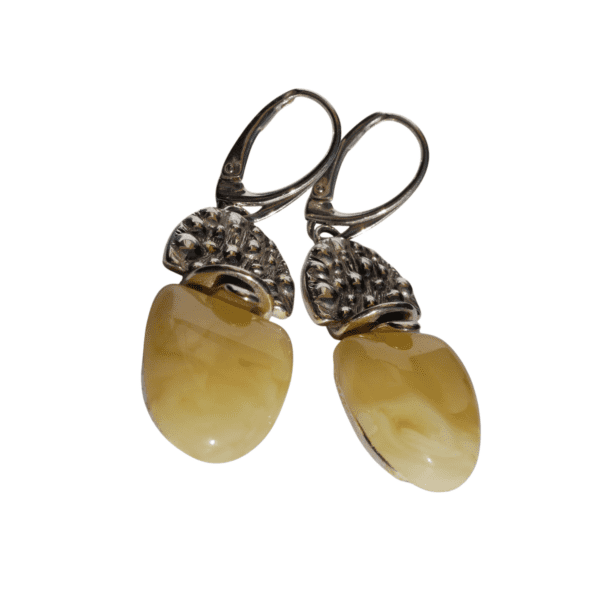 a pair of earrings with a white stone