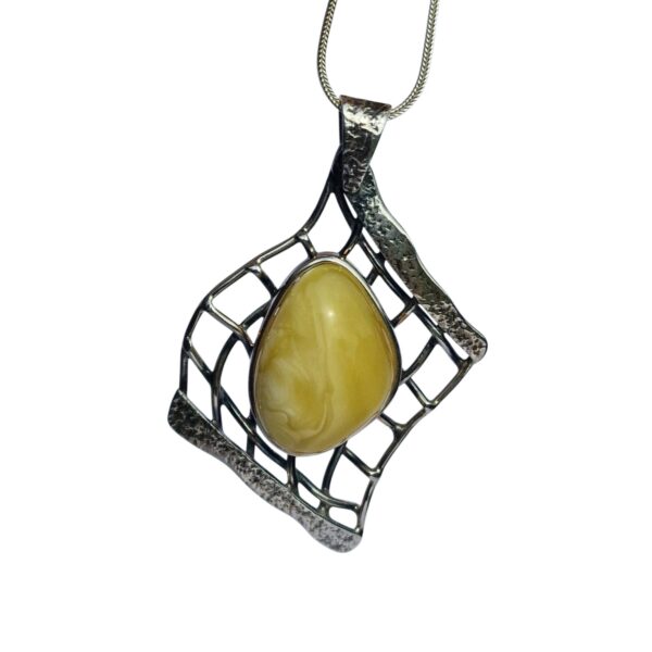 The AMBER EMBRACE: BUTTERSCOTCH AMBER & SILVER NET PENDANT SET features a silver pendant with an amber cabochon in an abstract web-like design on a chain.