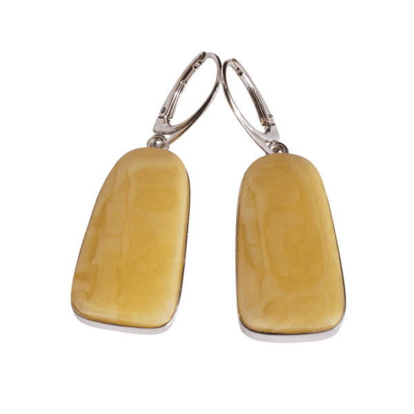 a pair of earrings with a yellow stone