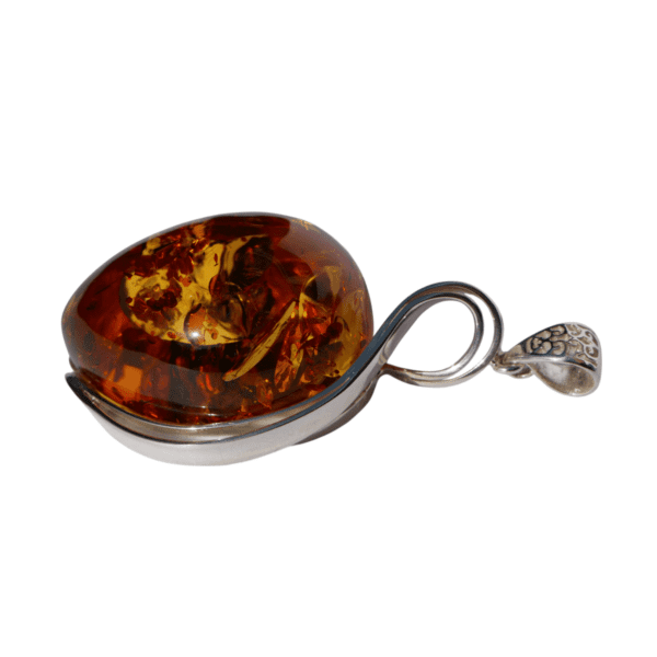 a amber pendant on a silver spoon