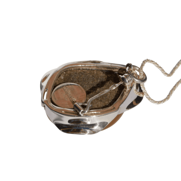 a coin in a silver container