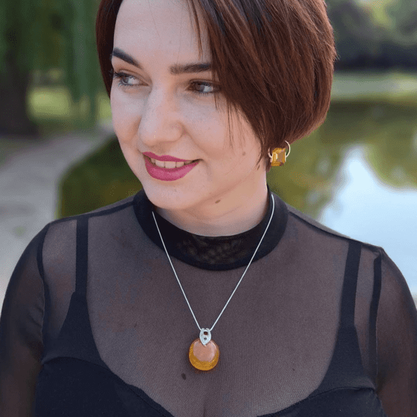 a woman wearing a black shirt and a necklace